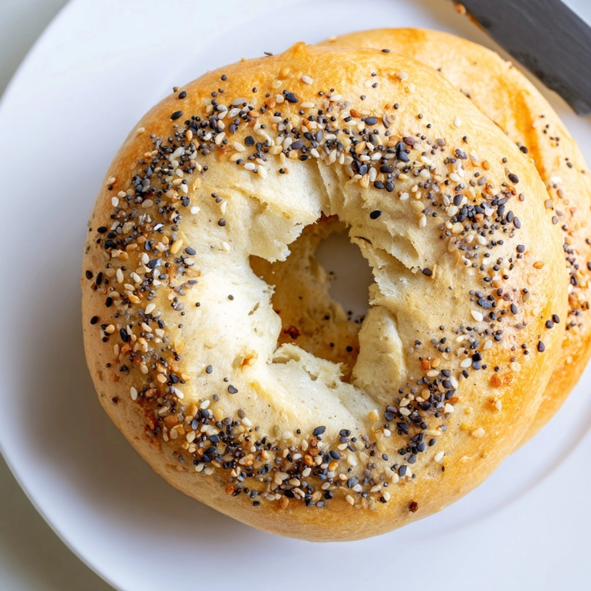 Close-up of a chewy 2-Ingredient Protein Bagel cut in half, ready to be enjoyed.