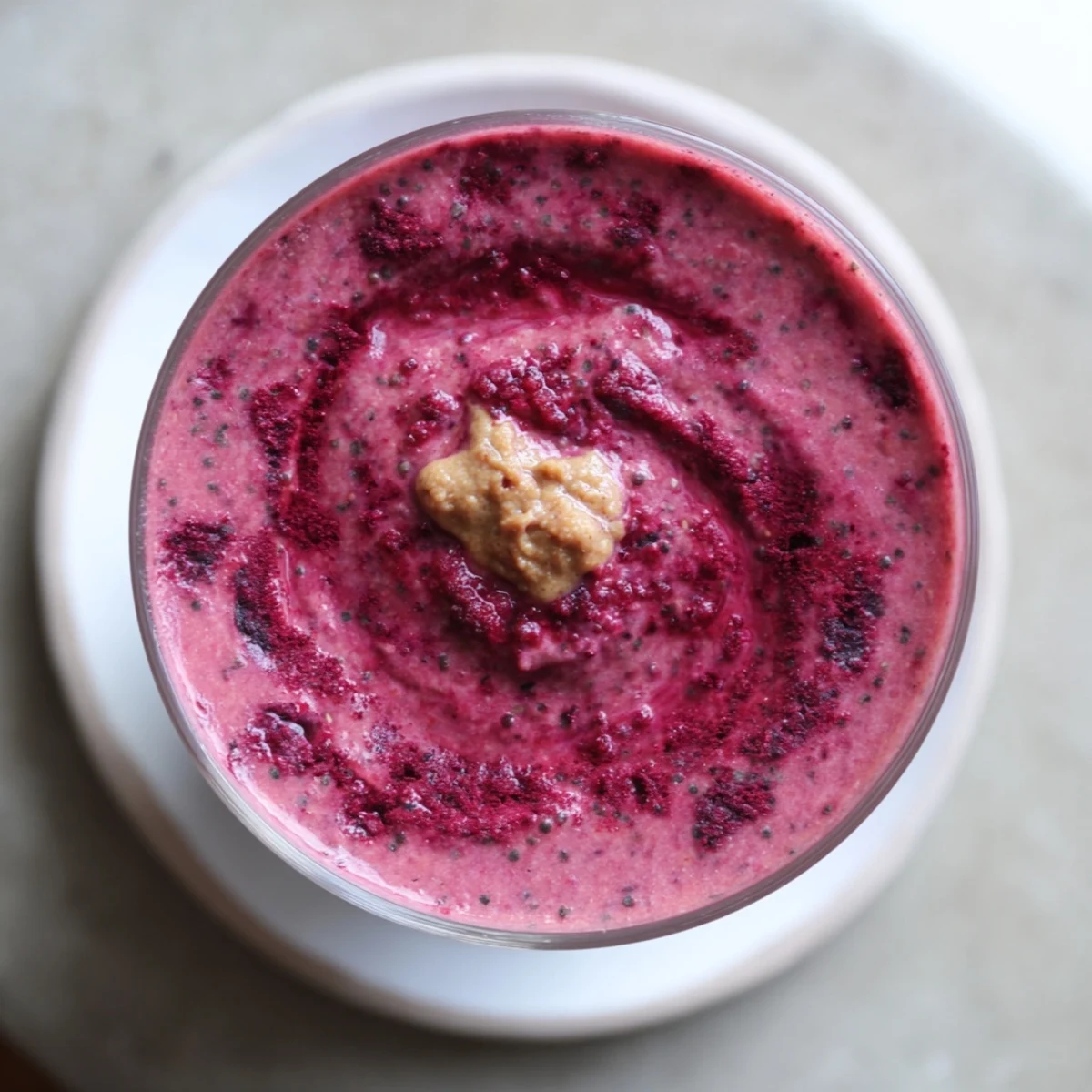 Vibrant Winter Harvest Paleo Smoothie, blended smooth, ready to refresh with pear and apple pieces.