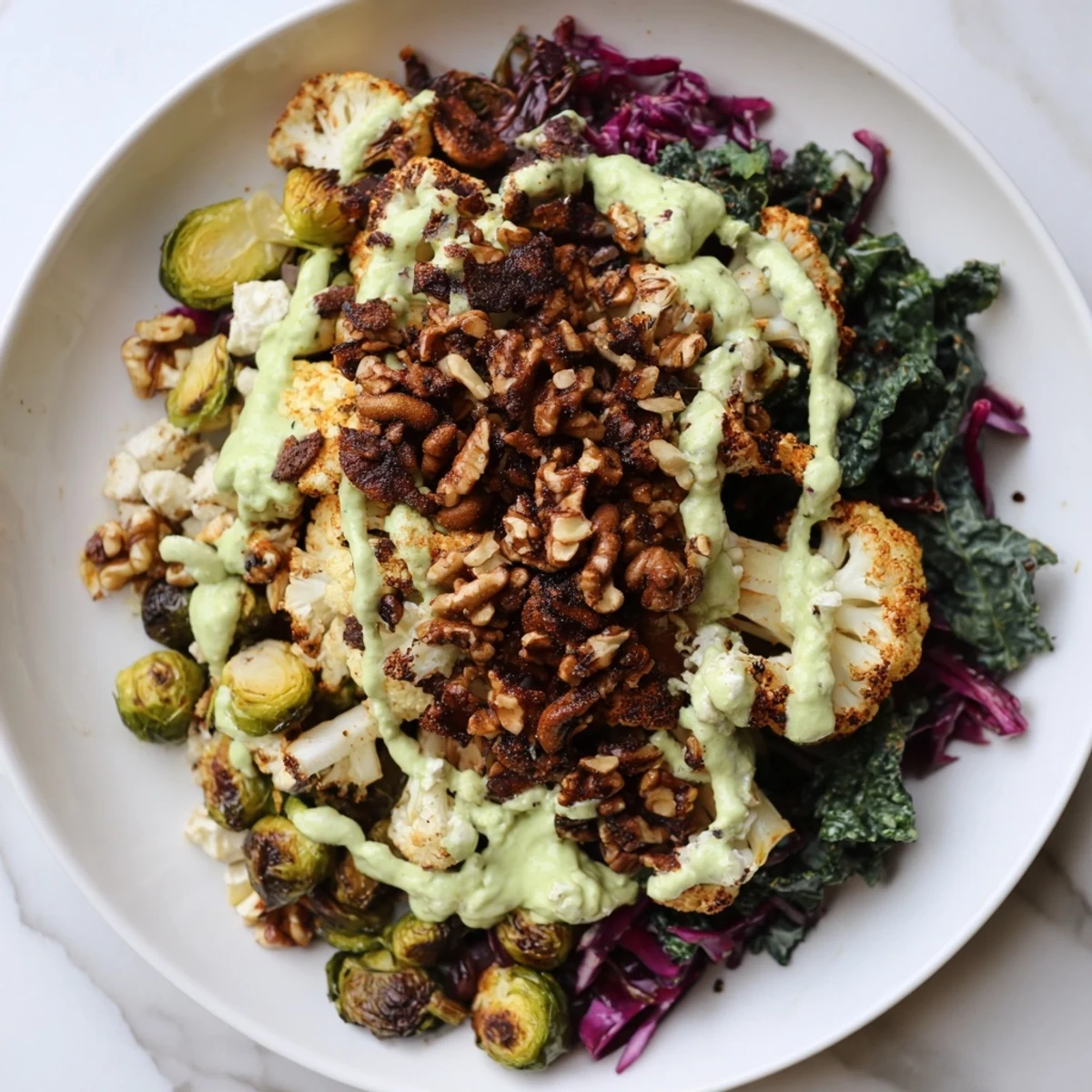 A Keto Winter Garden Grain Bowl with colorful roasted vegetables, topped with creamy avocado dressing.