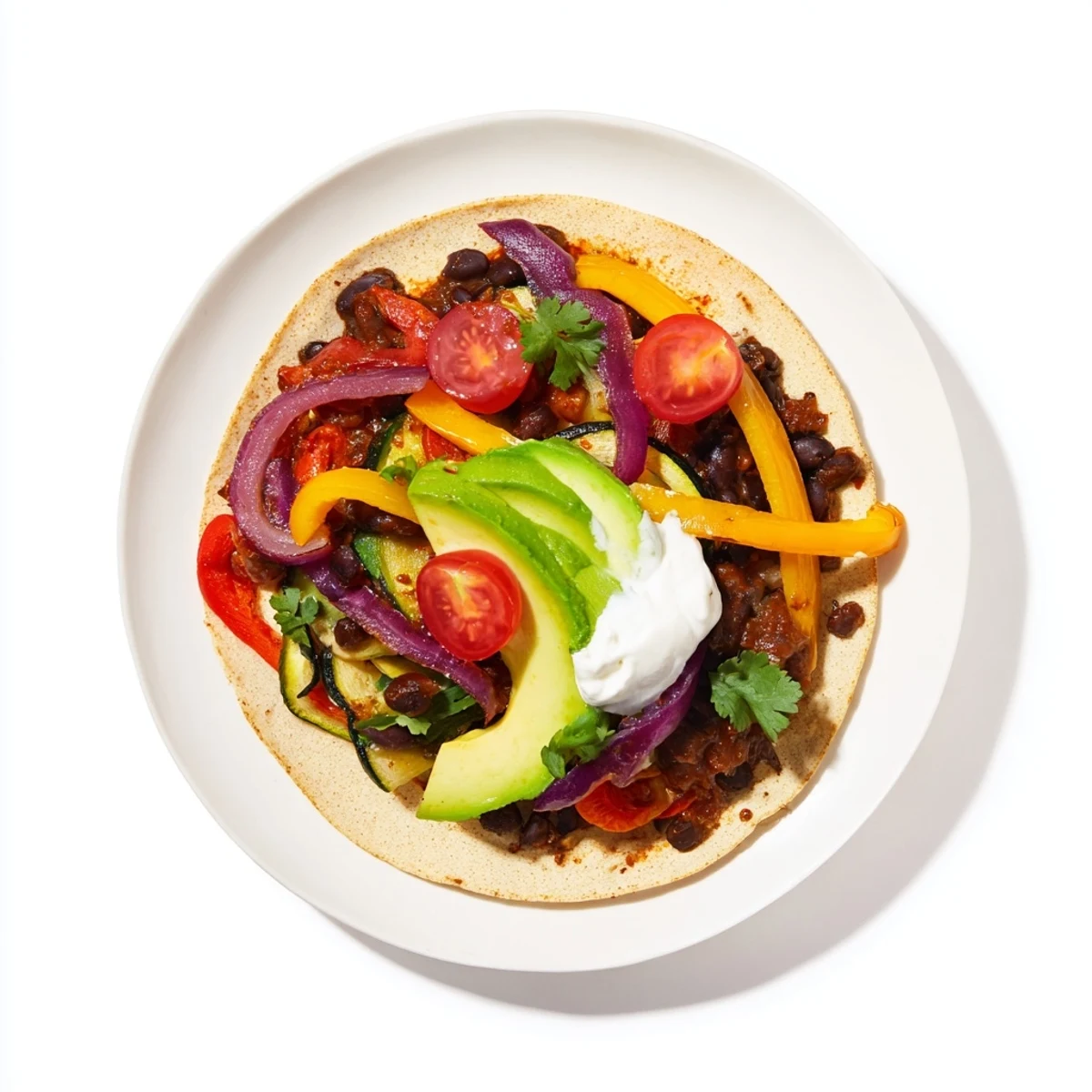 Close-up of freshly made Evergreen Vegan Tacos, showcasing black beans, cilantro, and bright red tomatoes, ready to eat.