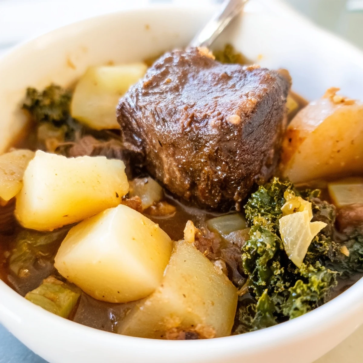 Winter Harvest Keto Stew simmers in a Dutch oven with tender beef cubes and chunky winter vegetables like celery root and turnip for a cozy keto dinner.