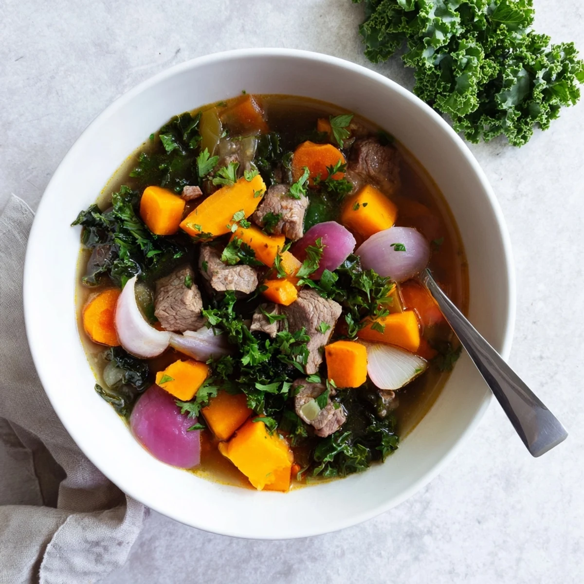A close-up of a warm bowl of Seasonal Glow Paleo Stew, garnished with fresh parsley for a vibrant finish.