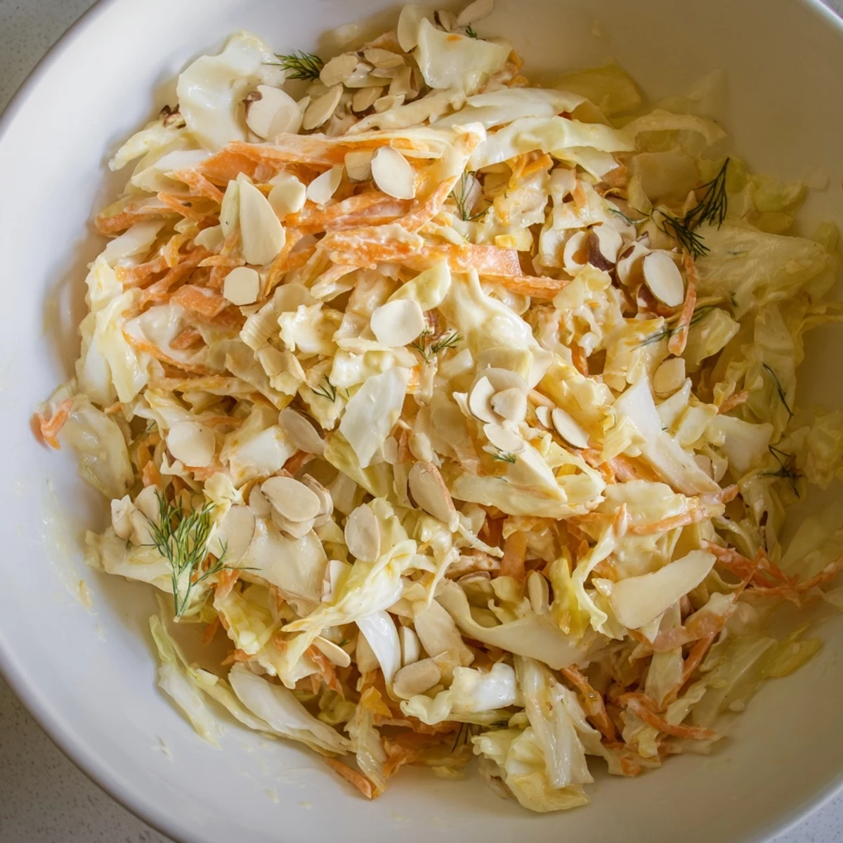 Freshly prepared Snowy Day Low Fat Salad tossed with tangy lemon-dill dressing and crunchy winter vegetables on a white plate.