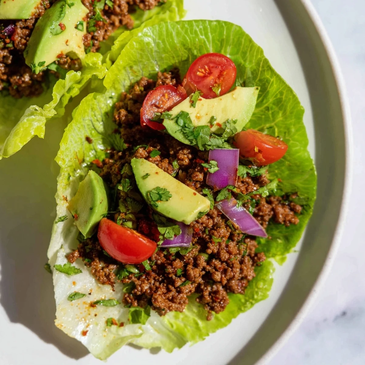 Freshly prepared Warm Hearth Paleo Tacos filled with savory ground beef, cherry tomatoes, and jalapeños, showcasing a vibrant gluten-free dinner.
