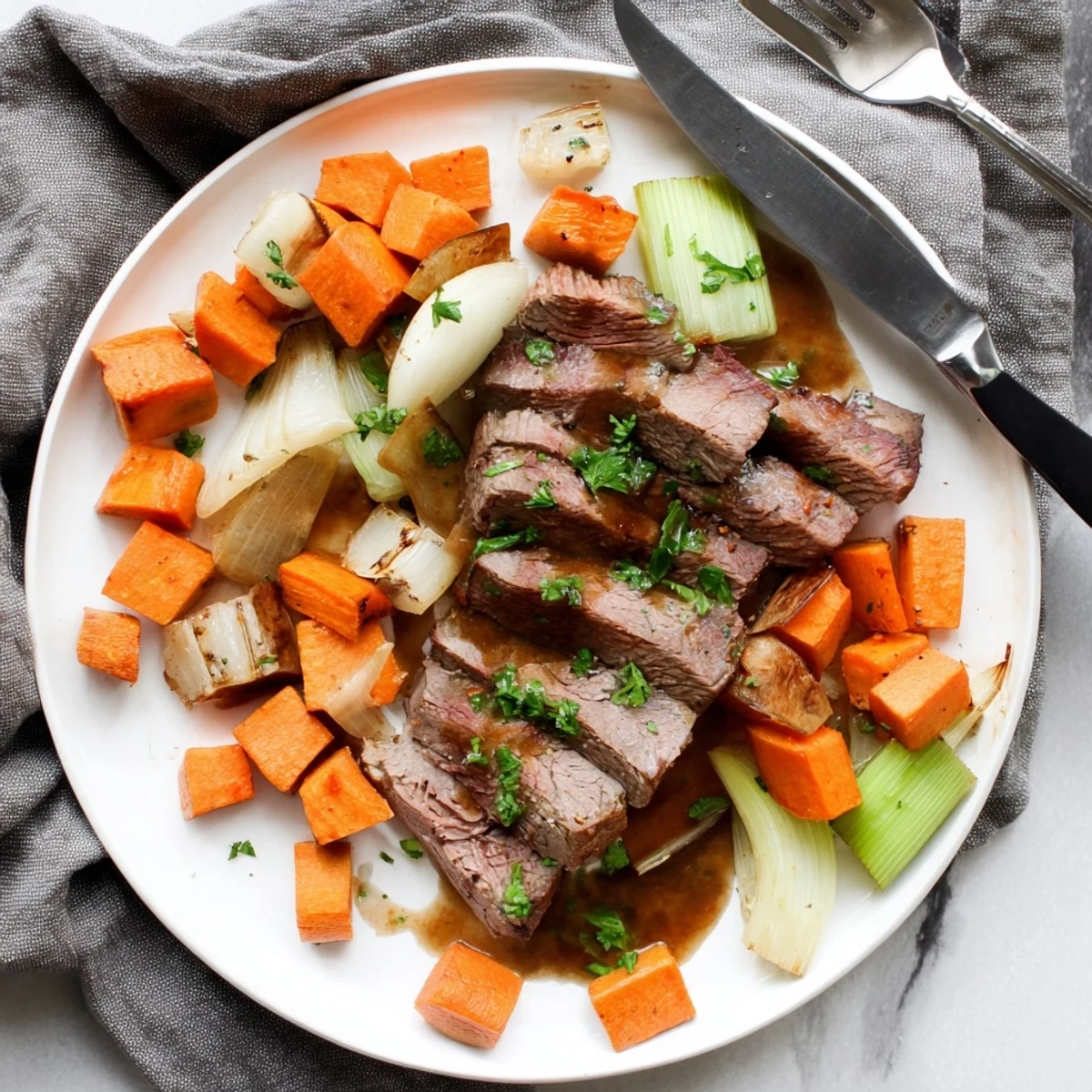 A rustic Dutch oven holds the hearty Winter Wellness Paleo Roast, served with aromatic thyme and rosemary.
