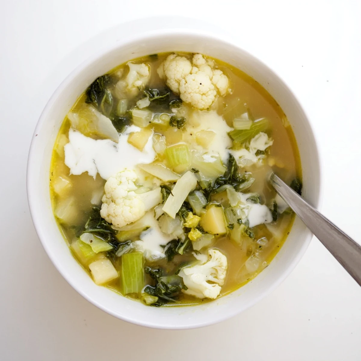 Winter Garden Keto Soup served in a rustic bowl, garnished with fresh thyme and rosemary.