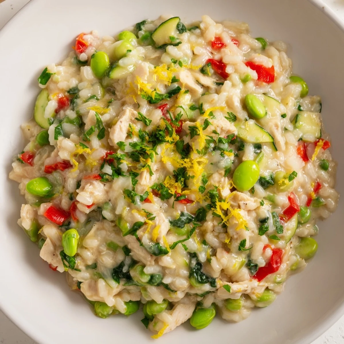 Golden Solstice High Protein Risotto topped with Parmesan, showcasing tender vegetables and high protein chicken for a nourishing meal.