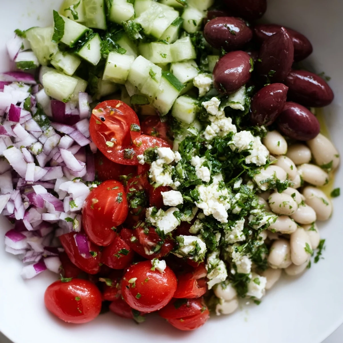 Vibrant Mediterranean white bean and cucumber salad bowl with diced vegetables and fresh herbs