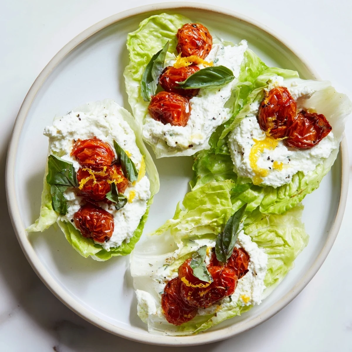 Crisp butter lettuce cups filled with fluffy whipped ricotta and sweet roasted cherry tomatoes