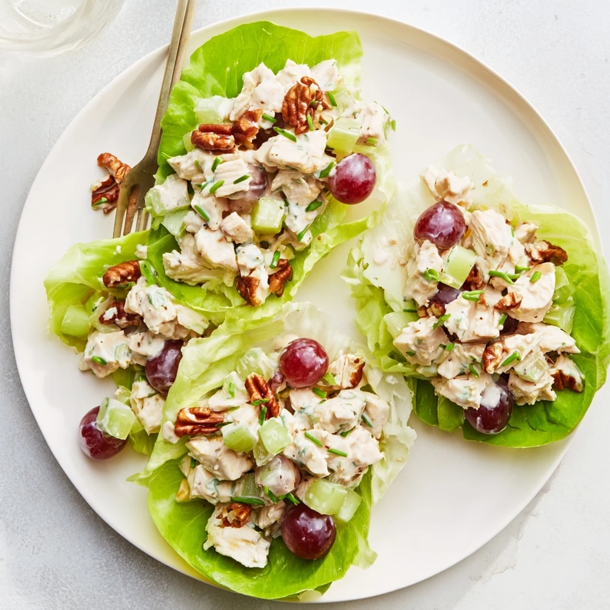 Golden chicken salad with cottage cheese and honey mustard dressing nestled inside fresh lettuce leaves for a light lunch