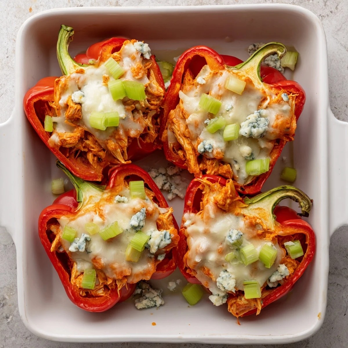 Golden baked cottage cheese buffalo chicken stuffed peppers with melted cheese topping
