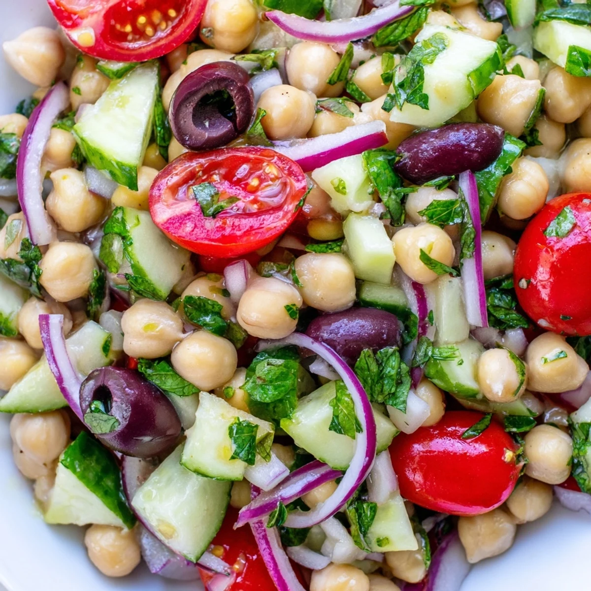 Fresh Mediterranean chickpea salad tossed in zesty lemon oregano dressing with colorful vegetables