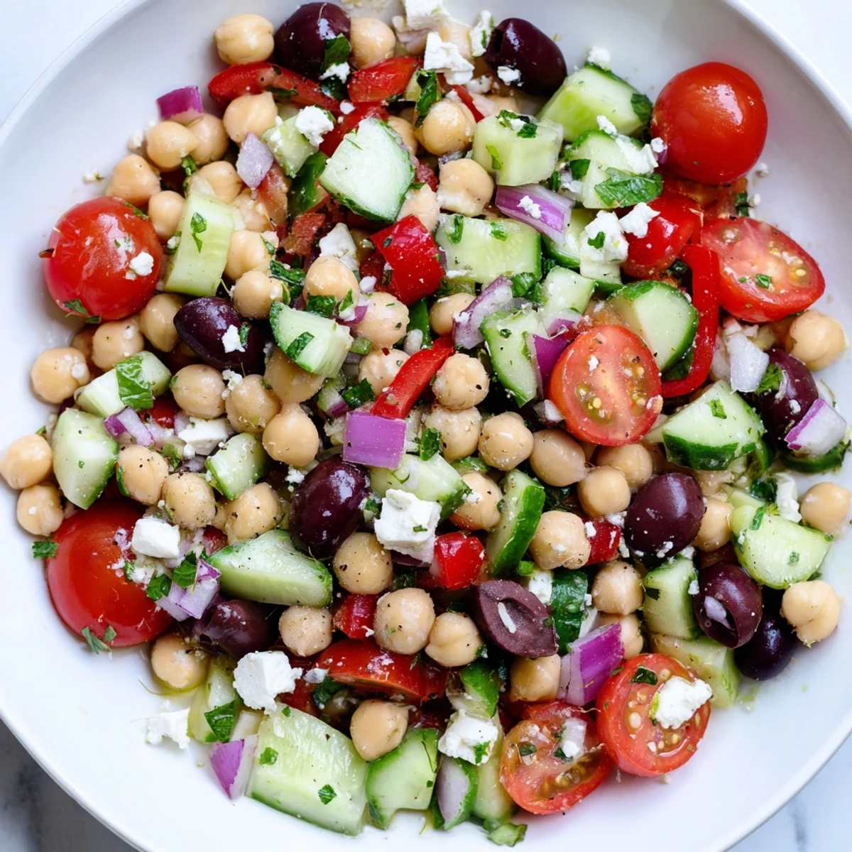 Mediterranean chickpea salad featuring ripe cherry tomatoes, crunchy cucumber, and vibrant bell pepper pieces