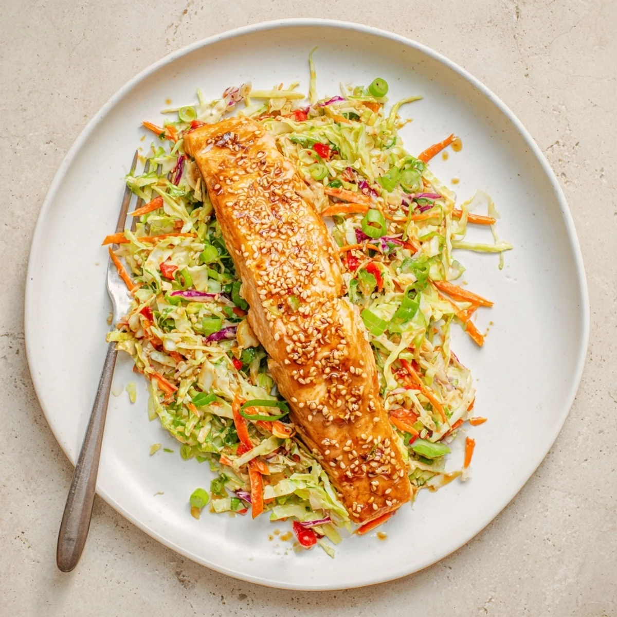Caramelized miso ginger salmon served over crisp shredded cabbage with toasted sesame seeds